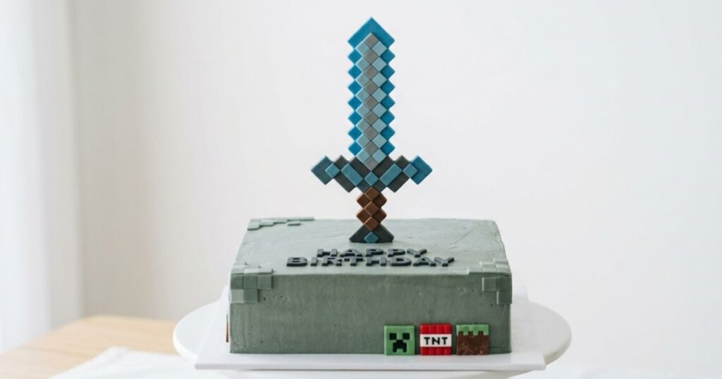 minecraft birthday cake smooth green buttercream base standing fondant diamond sword topper blue grey fondant squares upright
